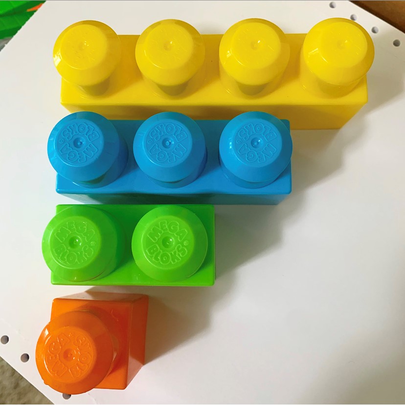 four colorful blocks arranged in order from smallest to largest