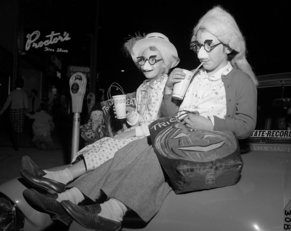 Groucho Marks glasses, wigs, and hats complete the look for these youngsters trick-or-treating on Main Street, in 1958. Image from The State Photograph Archive.