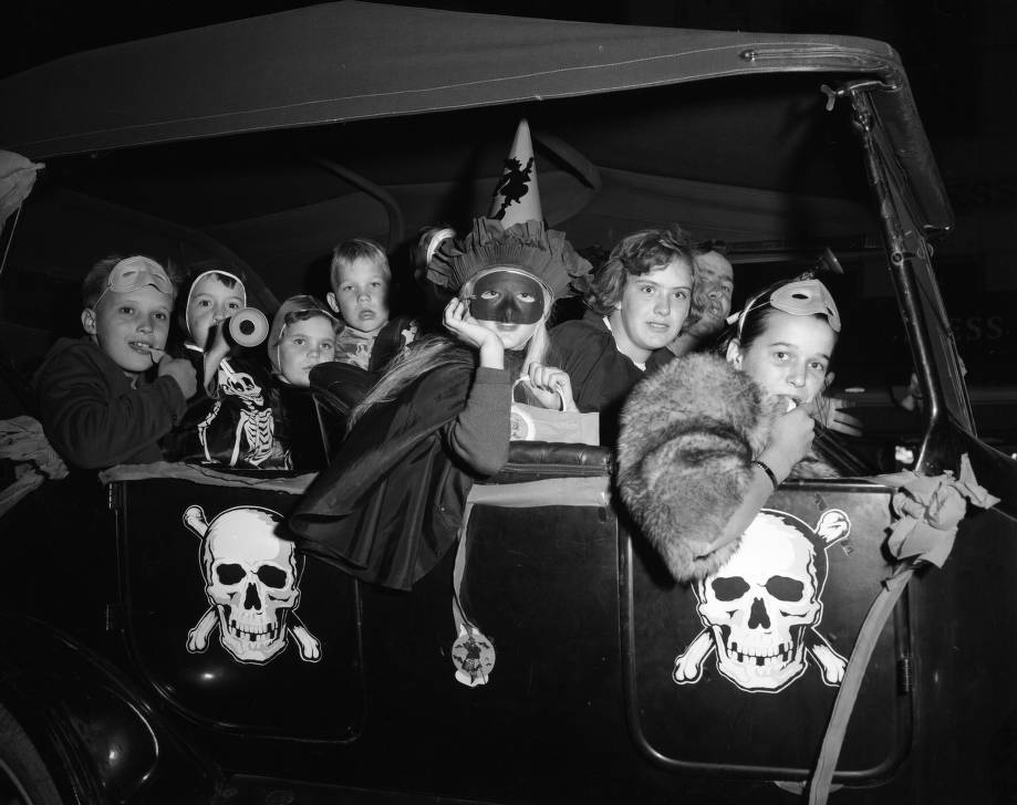 Carload of children in Halloween costumes, 1958