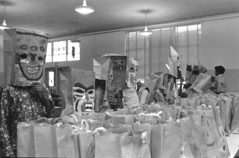 Students of the Waverly Center make Halloween masks from brown grocery bags during a class party, 1977. Image from The State Newspaper Photograph Archive.