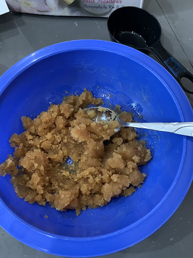 Blue bowl filled with brown sugar scrub