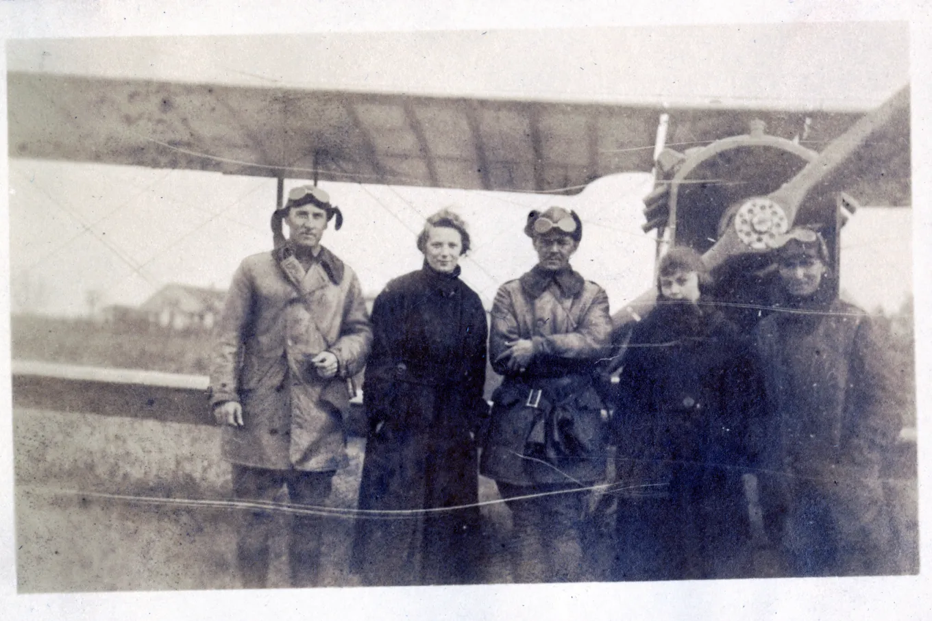 Lt. Pope, Mrs. Adams, Lt. Miller, Minnie Gosney, and Sgt. Fleming in front of airplane