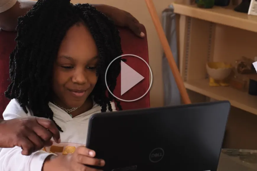 Young Girl uses laptop with library hotspot