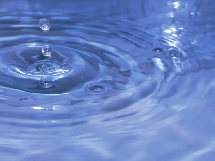 droplet of water in large body of water