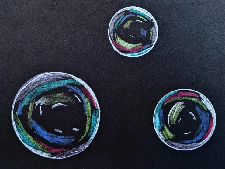 On black paper, a colored pencil drawing of three various sized bubbles