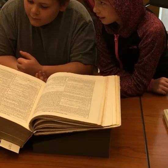 two children looking at a book
