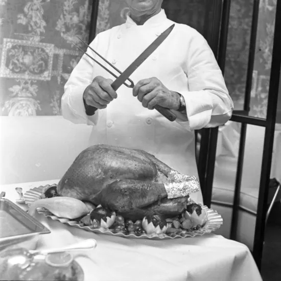 Image of a chef with a roasted turkey.