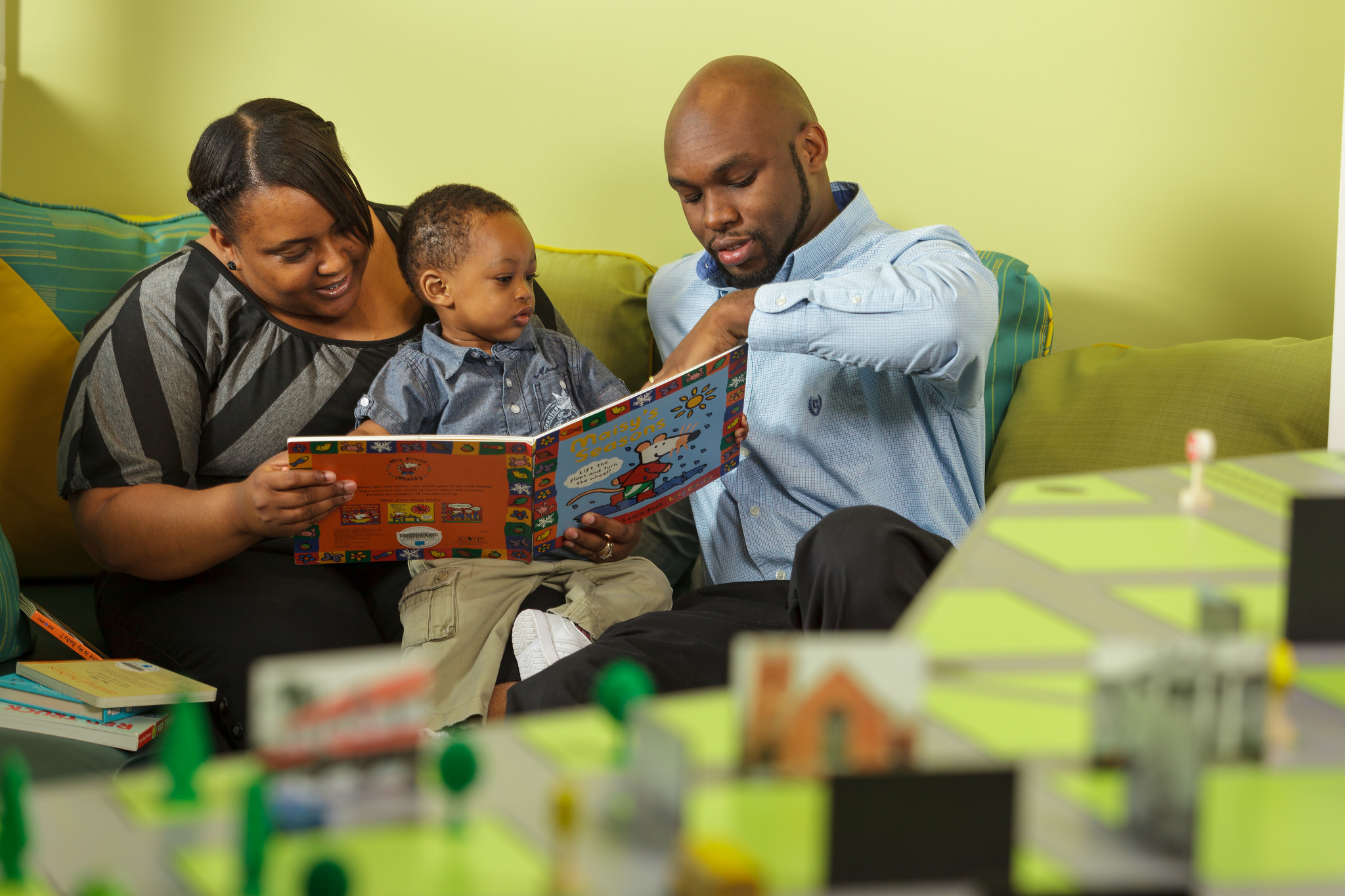 Family reads to a young child. 