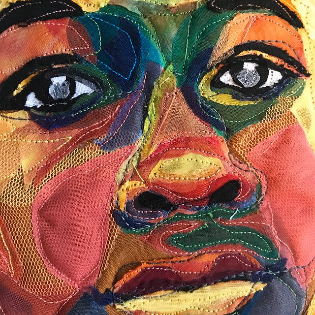 A close-up image of a Black boy's face from a Bisa Butler quilt titled The Mighty Gents