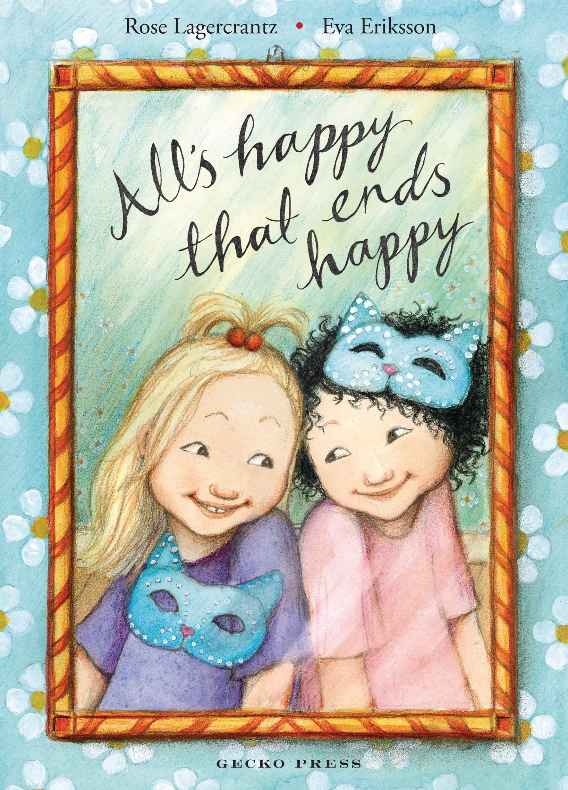 Two young white girls lean against each other, smiling in a framed photo | One girl has her blonde hair in a top knot.  She wears purple shirt and has a blue cat mask around her neck | The other girl has dark curly hair and is wearing a pink shirt.  She has a blue cat mask pushing up her hair.