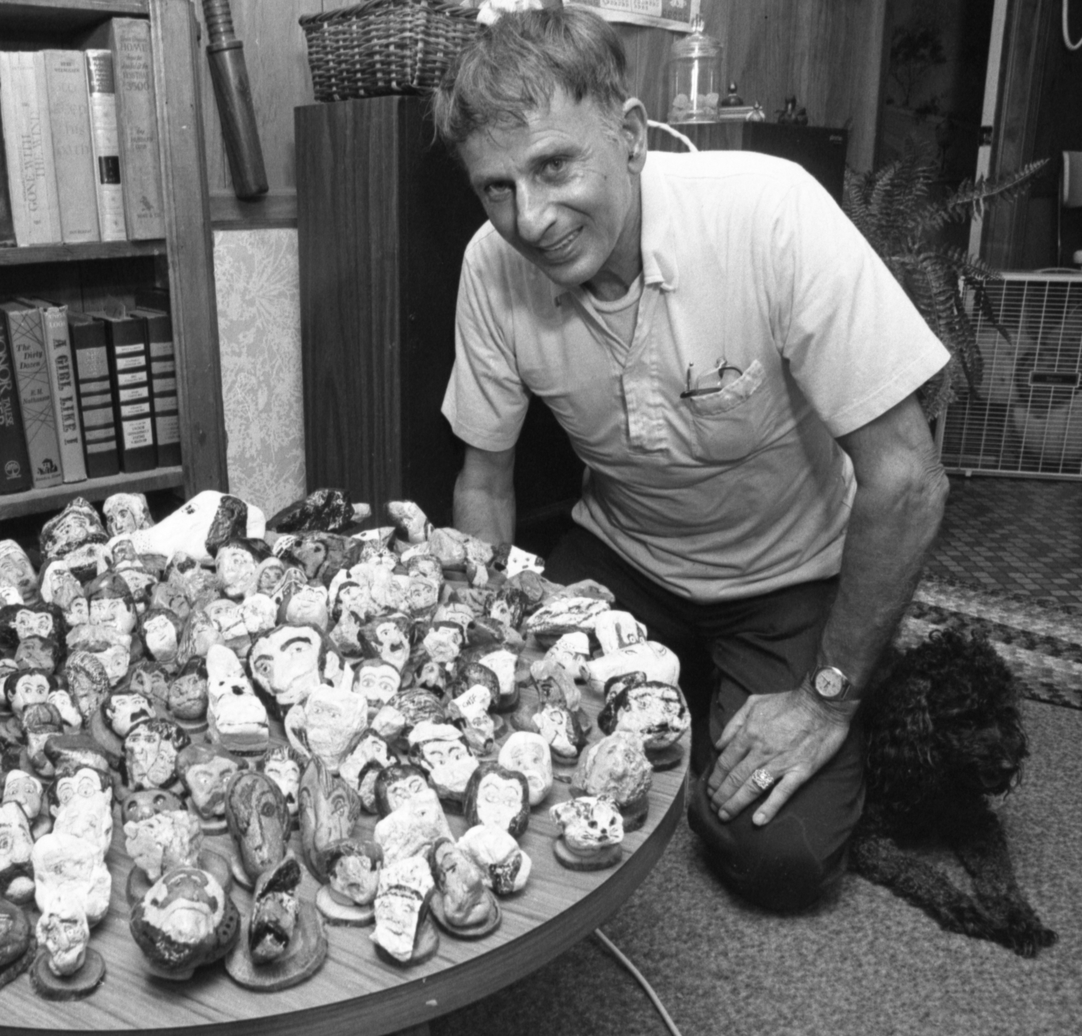 Frank LaRosa and furry friend pose with his many petrographic creations.