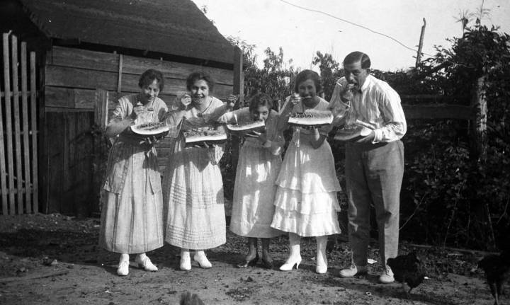 Group eating watermelon, 1918. Epting Collection.