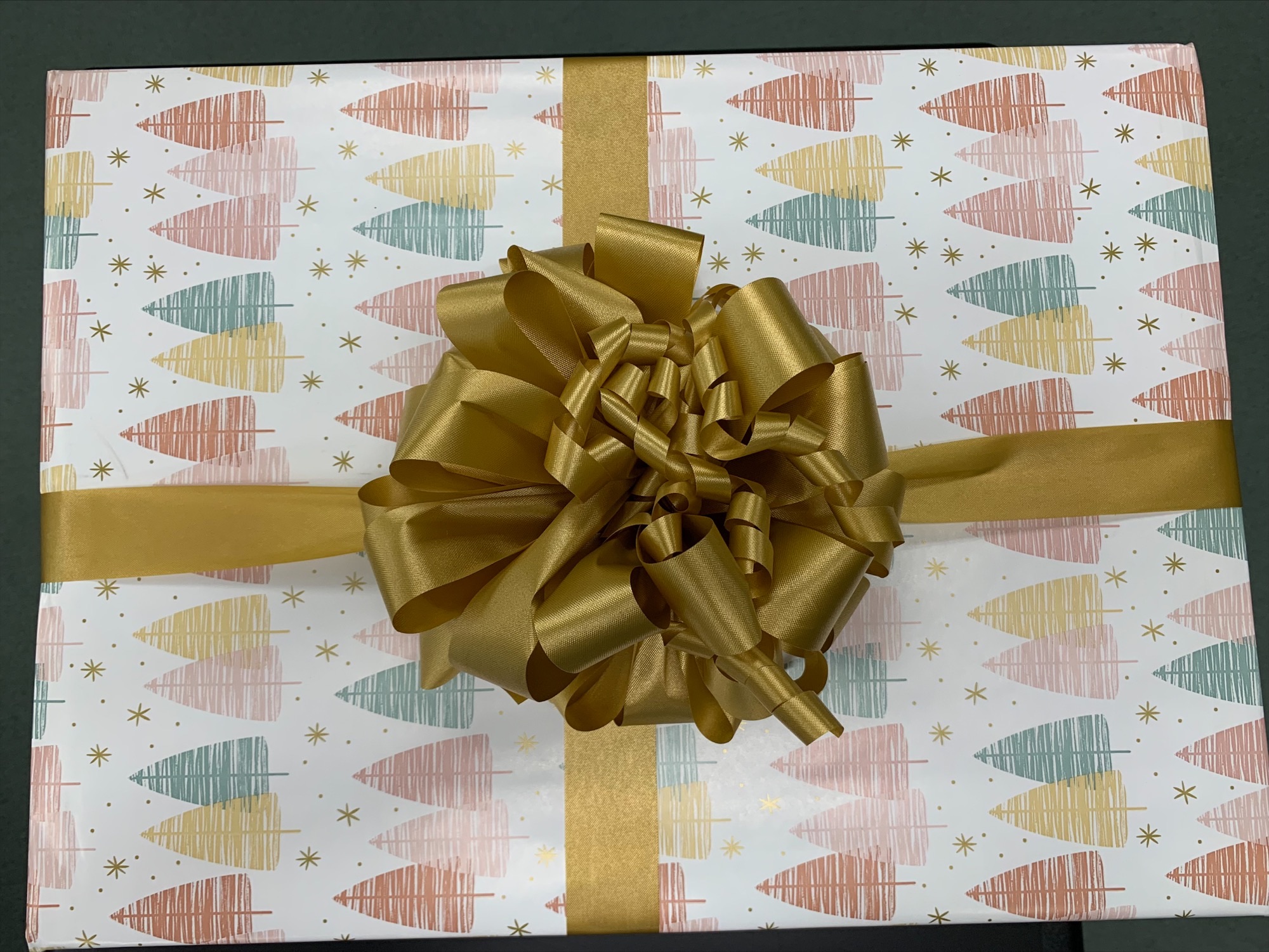 the finished product - the present is wrapped with a fluffy gold bow