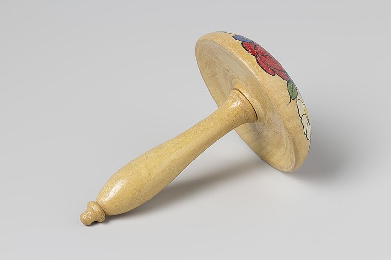 Wooden hand tool shaped like a mushroom. The top is painted with flowers and the handle is plain