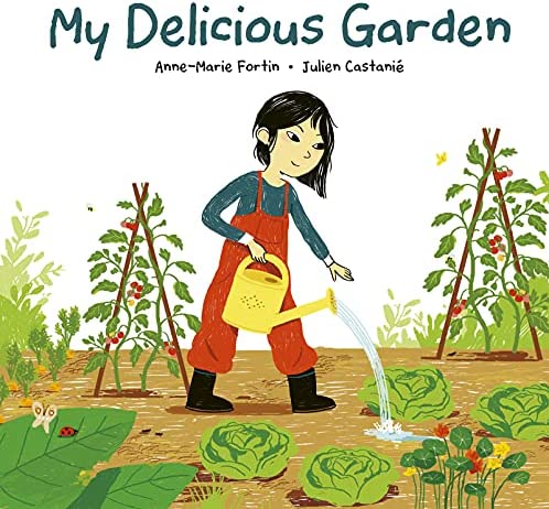 Cover of My Delicious Garden | A young Asian girl stands in the middle of a vegetable garden with cabbages and bean tent poles.  She is holding a yellow watering can and is watering the garden.  She is wearing red overalls and a blue long-sleeve shirt.  Her hair is chin length and one side is tucked behind her ear.  