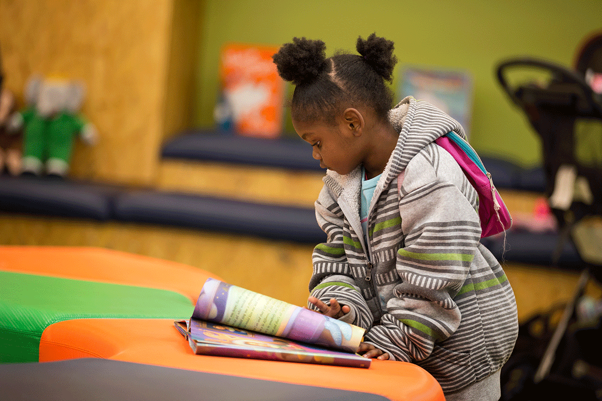 Child reads a book at Richland Library