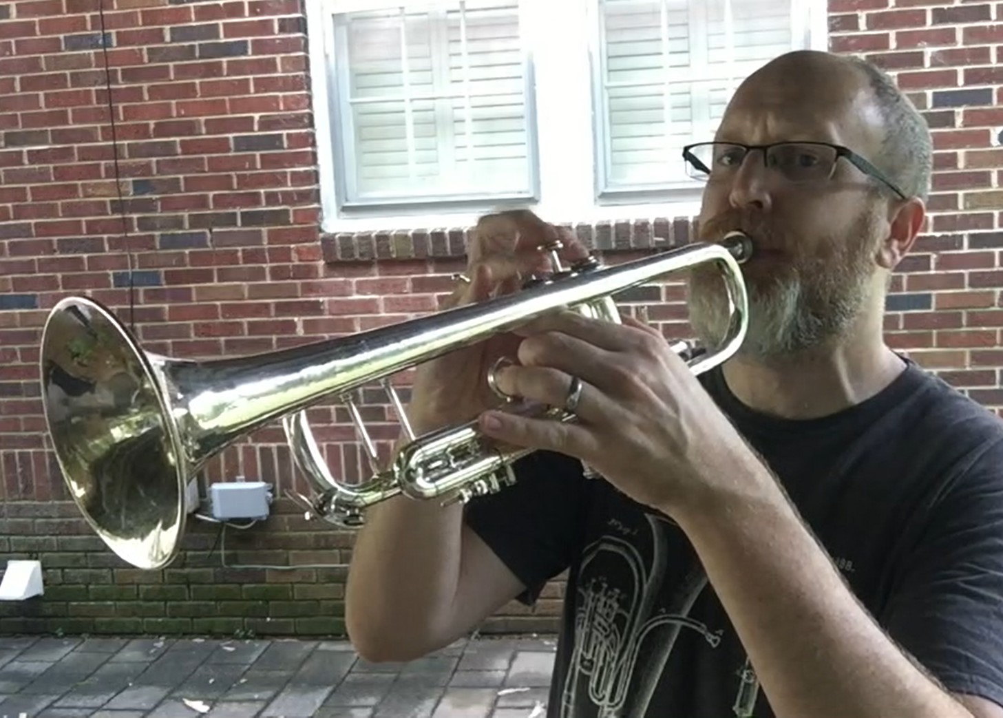 Music teacher Roger Keane playing the trumpet