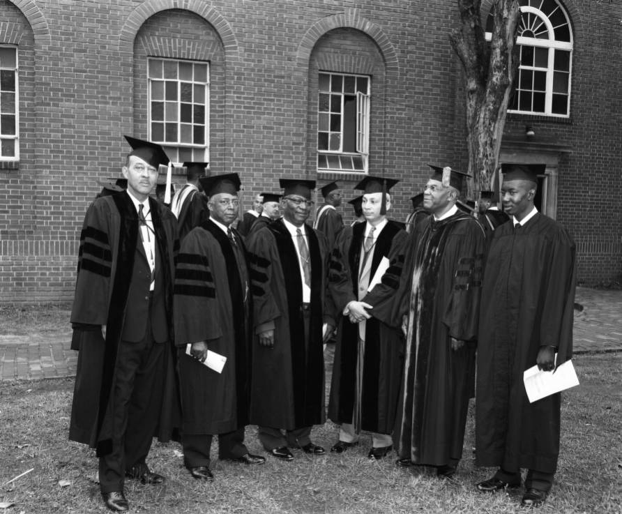 Six men wearing caps and gowns at Benedict College Commencement
