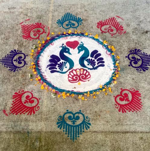 Rangoli design with peacock and flowers