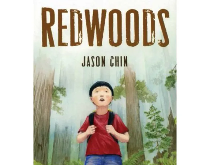 Cover of Redwoods by Jason Chin.  The setting is a slightly foggy redwood forest.  A young Asian boy stands in the middle with his hands on his backpack straps.  He wears a red t-shirt and jeans.  He looks up in wonder.