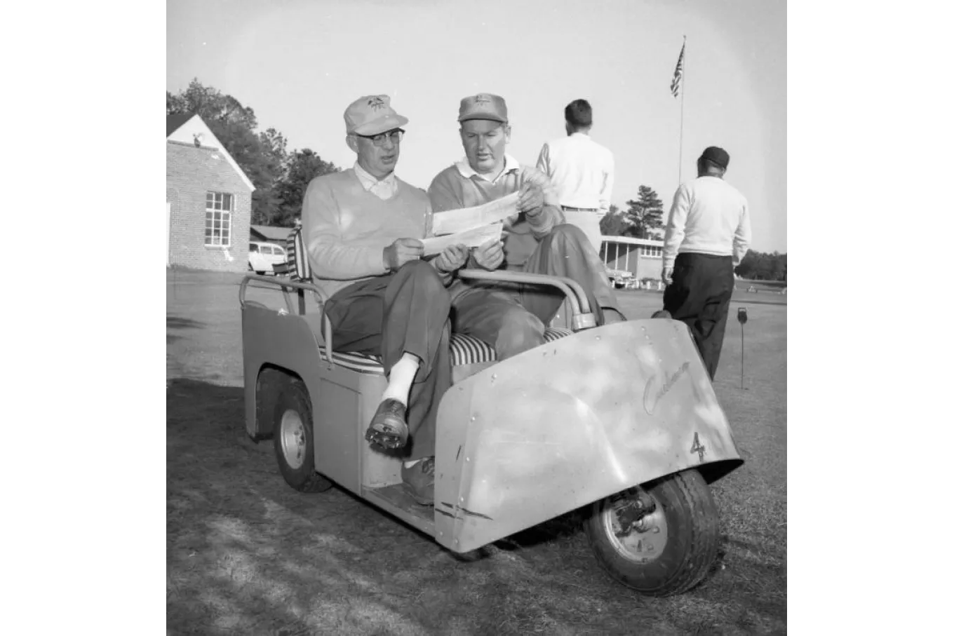 Golfers in a cart.