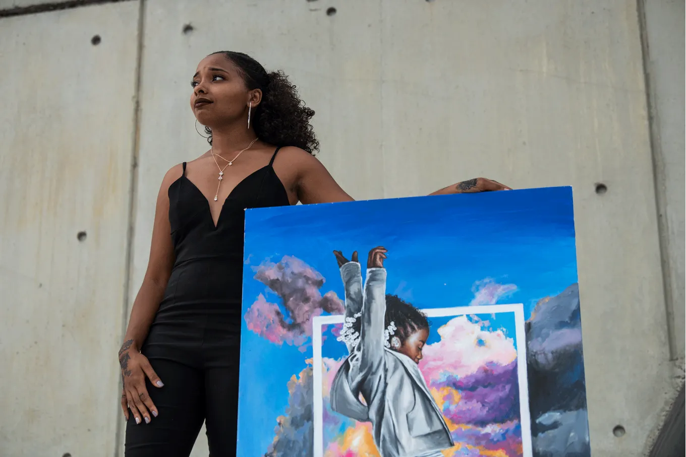 Artist Ija Charles with her acrylic painting of Leap
