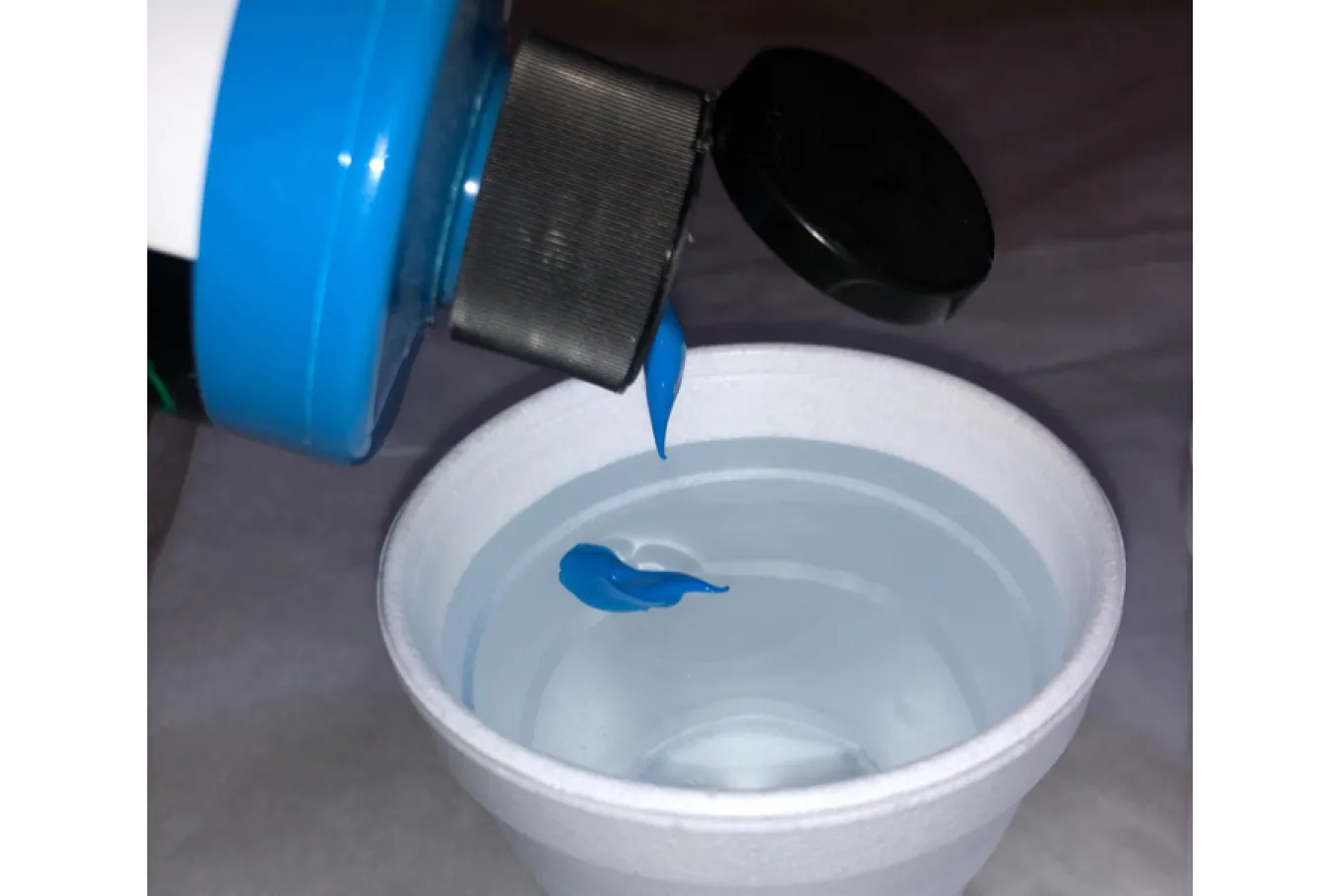 Blue Acrylic Paint squeezed into cup of water