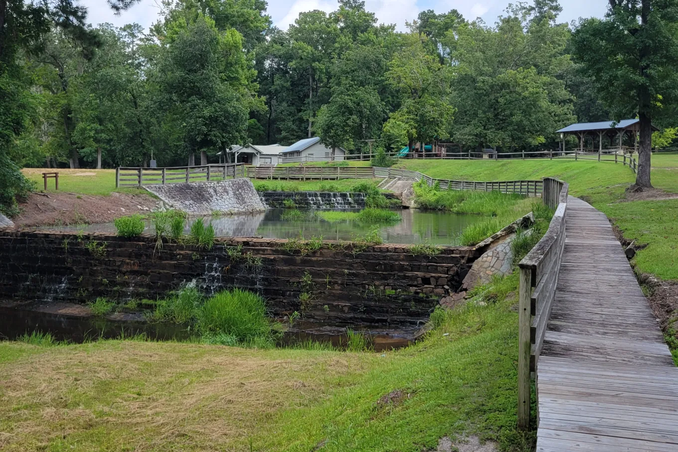 Bridge next to a small, stone dam