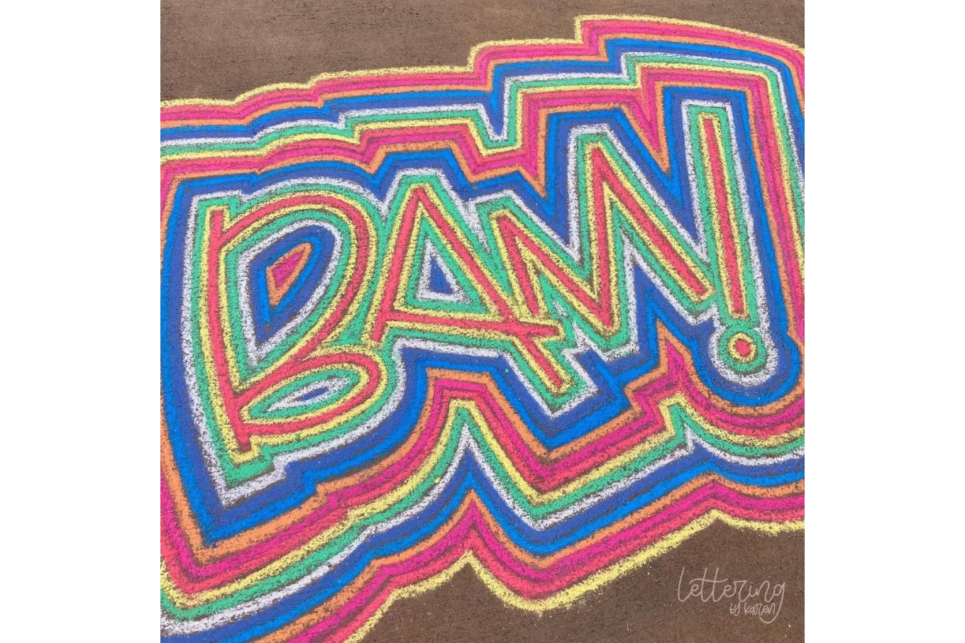 Chalk art that reads "BAM!" in red, yellow, blue, and green