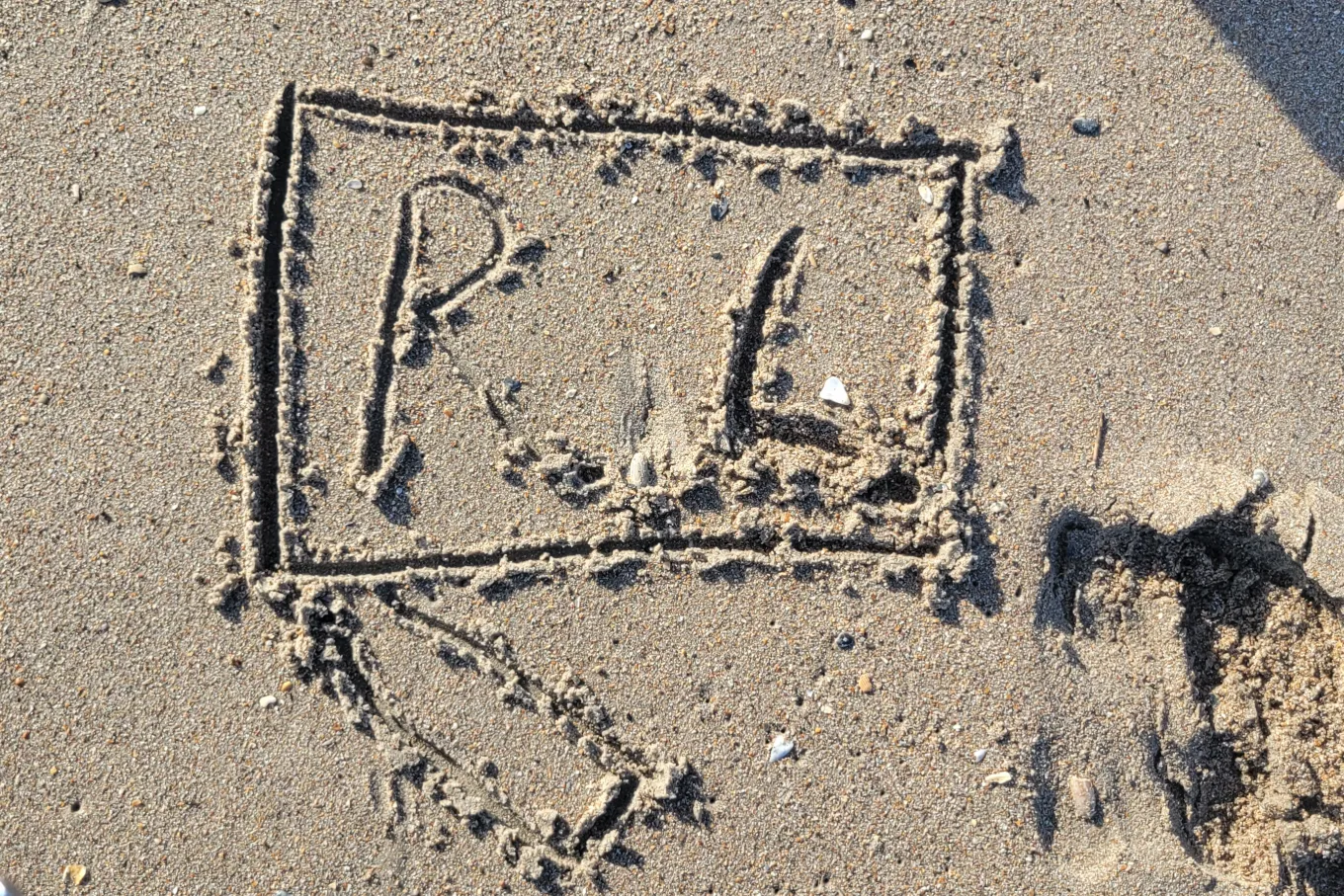 Richland Library logo drawn in sand