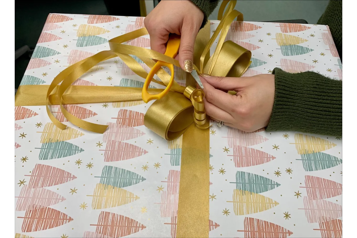 gold ribbon being tied into a bow
