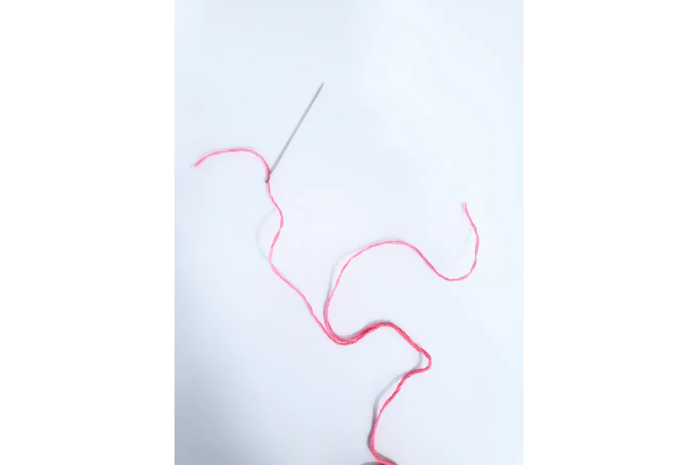 Pink embroidery floss split in half for needlework