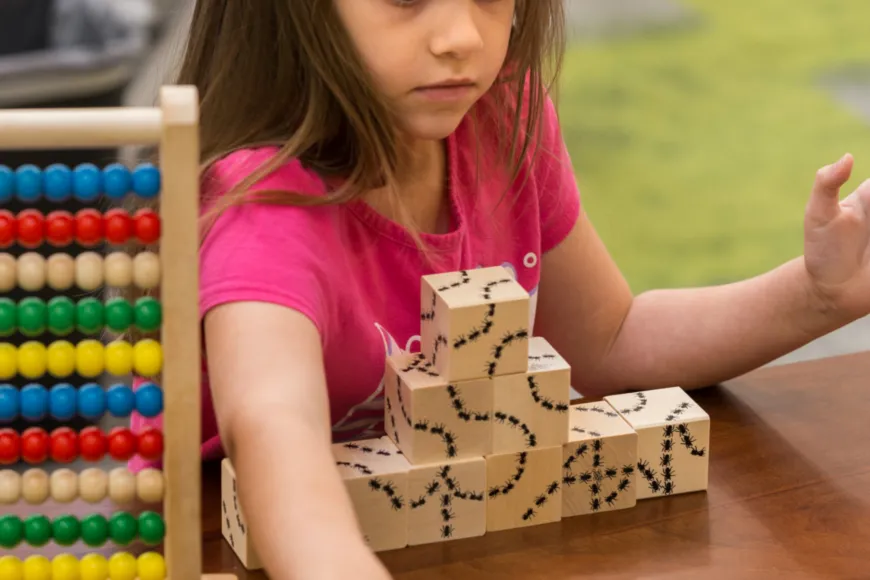 Girl building with blocks.