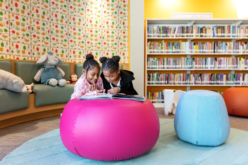 Two little girls reading at Edgewood