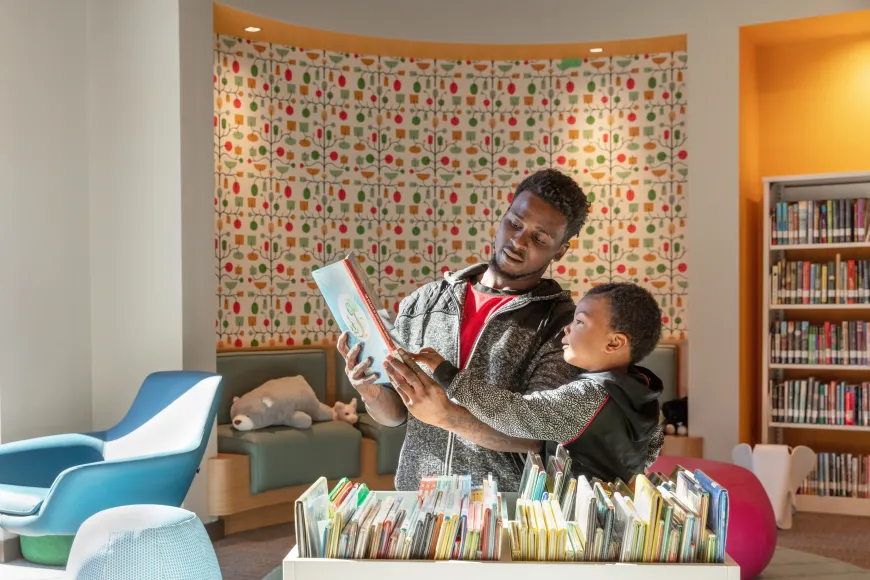 Father and son pick out books at Edgewood