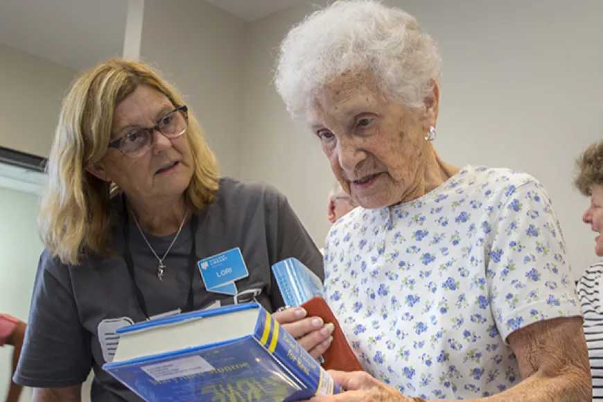 staff helping a customer pick out books