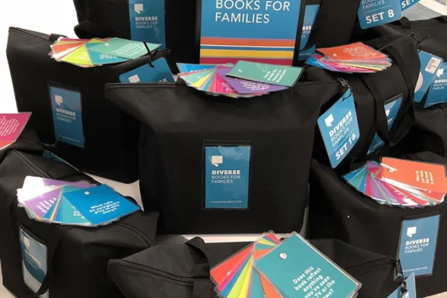 Black bags containing diverse book sets for families.