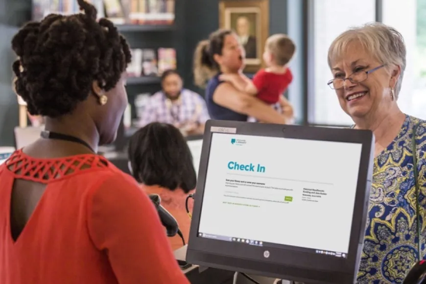 library staff member checks in a customer for a program