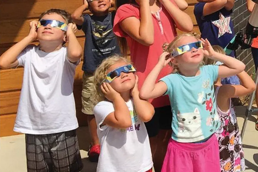 Children investigate the solar eclipse
