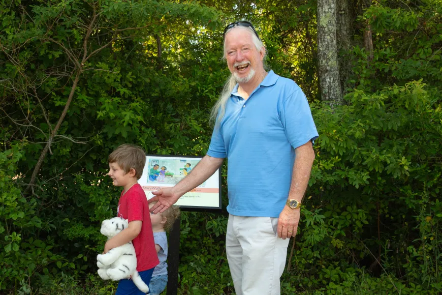 Family enjoys the StoryWalk at Doko Meadows in Blythewood