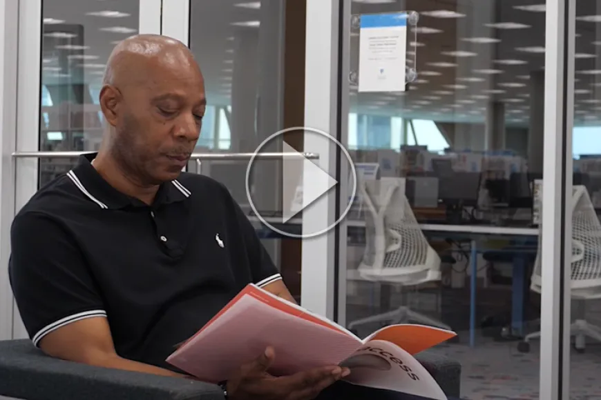Man reads magazine at Richland Library