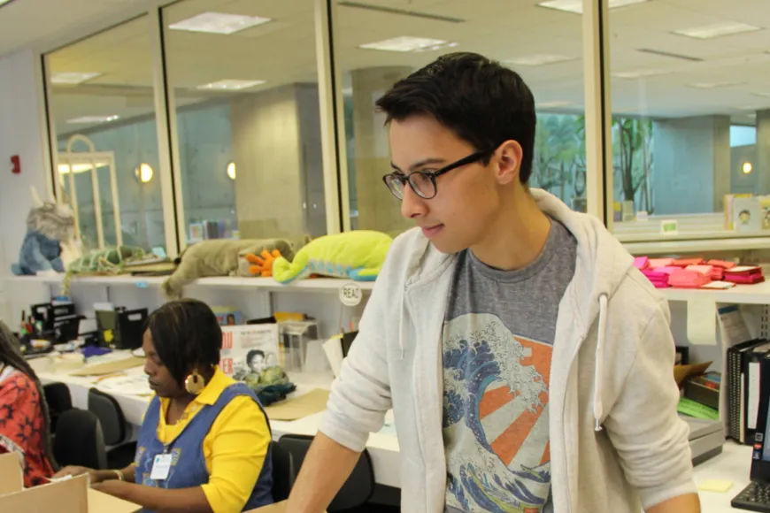 Young Man volunteers at Richland Library Main