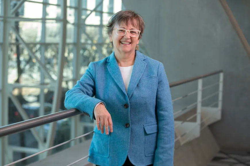 Cindy Cox stands in Richland Library Main wearing a bright blue blouse