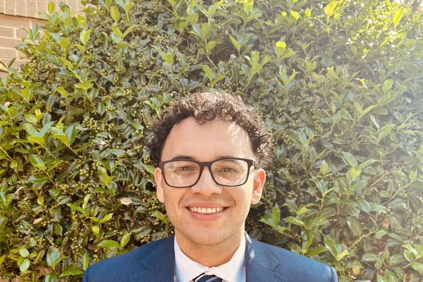 Headshot of Alejandro Jaramillo in a navy blue suit. 