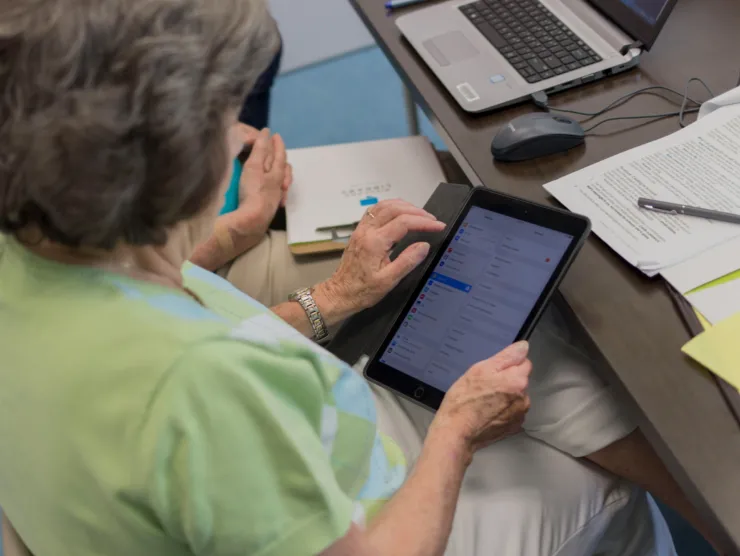 Woman holding a tablet.