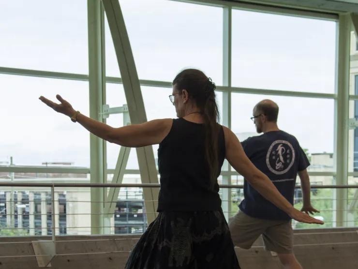 Learners practice Tai Chi in the library