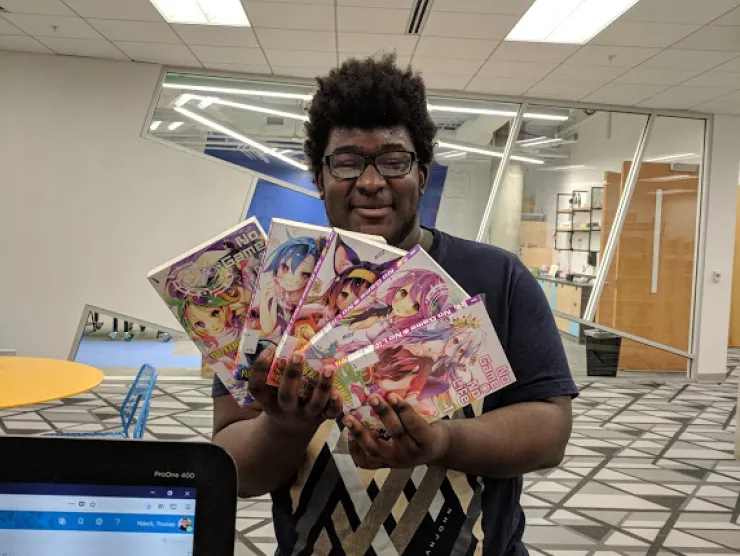 Teen shows off a collection of Manga at Richland Library