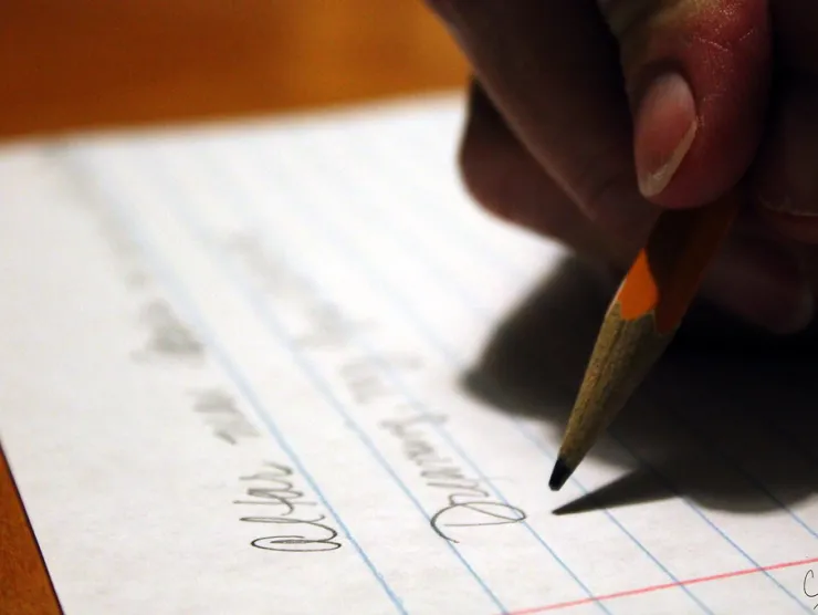 Hand writing on paper with a pencil
