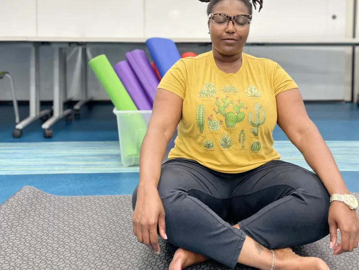Tyisha Henderson demonstrates a yoga sitting pose