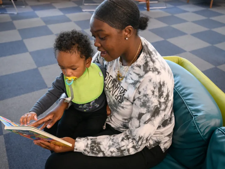 Mom reading to baby side view 